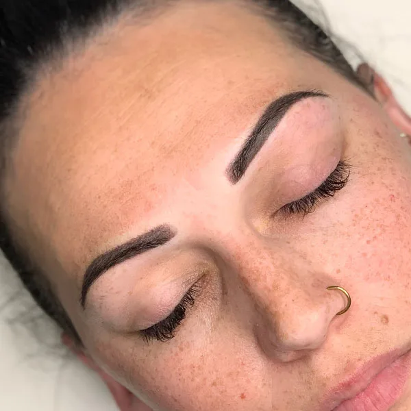 Eyebrow correction result — clean reshaped brows